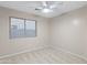 Bright bedroom featuring neutral walls and carpet, with a ceiling fan at 13723 W Rovey Ave, Litchfield Park, AZ 85340