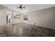 Open-concept living room with neutral paint, decorative ceiling fan and view to the kitchen at 13723 W Rovey Ave, Litchfield Park, AZ 85340