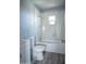 Bathroom featuring a tiled shower, toilet, vanity, and a window providing natural light at 1410 S 24Th Ave, Phoenix, AZ 85009