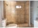 Tiled bathroom features a walk-in shower with tiled walls and neutral-toned fixtures at 1410 S 24Th Ave, Phoenix, AZ 85009