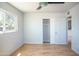 Sunlit bedroom with neutral walls, wood floors, closet, and a large window at 1410 S 24Th Ave, Phoenix, AZ 85009
