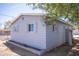 Side exterior view shows blue siding, white trim, and a neatly kept perimeter at 1410 S 24Th Ave, Phoenix, AZ 85009