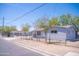 Street view of quaint single-story home with neutral colors and a chain link fence at 1410 S 24Th Ave, Phoenix, AZ 85009