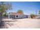 Rear exterior view of home shows an expansive lot with blue skies and mature trees at 1410 S 24Th Ave, Phoenix, AZ 85009