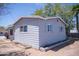 Exterior view of home shows blue siding and white trim surrounded by landscaping at 1410 S 24Th Ave, Phoenix, AZ 85009