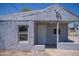 Charming front exterior with textured walls, a covered porch, and a secure window at 1410 S 24Th Ave, Phoenix, AZ 85009