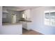 Bright kitchen featuring white cabinetry, stone countertops, and vinyl plank flooring at 1410 S 24Th Ave, Phoenix, AZ 85009