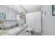 A calming bathroom featuring a granite sink, shower with a curtain, and decorative art at 14145 N 92Nd St # 1084, Scottsdale, AZ 85260