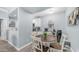 Cozy dining area with a wooden table, white chairs, and ample natural light from the adjacent kitchen at 14145 N 92Nd St # 1084, Scottsdale, AZ 85260