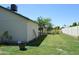Side view of the backyard, showcasing the house exterior and green lawn at 14626 N 40Th Way, Phoenix, AZ 85032