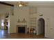 Cozy living room featuring a fireplace, tile floors, and archway to the hallway at 14626 N 40Th Way, Phoenix, AZ 85032