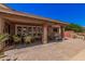 Cozy back patio features stone pavers, comfortable seating, and tranquil backyard views at 1473 Leisure World --, Mesa, AZ 85206