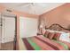 Cozy bedroom featuring ceiling fan, closet doors and a comfortable bed with decorative pillows at 1473 Leisure World --, Mesa, AZ 85206