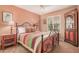 Comfortable bedroom with patterned bedspread, framed pictures, and natural light from the window at 1473 Leisure World --, Mesa, AZ 85206