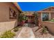 Inviting front entrance with a tiled walkway, decorative artwork, and colorful desert plants at 1473 Leisure World --, Mesa, AZ 85206