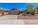 Attractive single-story home featuring desert landscaping, mature trees, and a two-car garage at 1473 Leisure World --, Mesa, AZ 85206