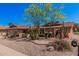 Lovely single-level home featuring desert landscaping, mature trees, and a two-car garage at 1473 Leisure World --, Mesa, AZ 85206