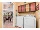 Laundry room with colorful cabinets and modern washer and dryer units at 1473 Leisure World --, Mesa, AZ 85206