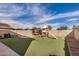 A spacious backyard with artificial grass, a playground, and a block wall at 15339 N 148Th Ct, Surprise, AZ 85379