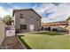 Backyard with artificial turf, patio, and block fencing at 15339 N 148Th Ct, Surprise, AZ 85379