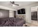 Well-lit bedroom showcasing a dresser, ceiling fan, and entrance to the bathroom at 15339 N 148Th Ct, Surprise, AZ 85379