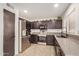 Spacious kitchen showcasing stainless steel appliances and gray countertops, with a pantry door at 15339 N 148Th Ct, Surprise, AZ 85379