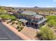 Expansive luxury home with desert landscaping, a circular driveway, four-car garage and mountain views at 15427 E Firerock Country Club Dr, Fountain Hills, AZ 85268
