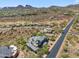 Aerial view of neighborhood, a blacktop street, desert surroundings, and a grey tiled home at 15427 E Firerock Country Club Dr, Fountain Hills, AZ 85268
