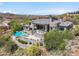 Backyard aerial view of home with a pool, hot tub, lounging patio, and surrounding desert foliage at 15427 E Firerock Country Club Dr, Fountain Hills, AZ 85268
