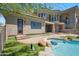 Backyard with artificial turf, pool with bar-stool seating, stone details, and a view of the main house at 15427 E Firerock Country Club Dr, Fountain Hills, AZ 85268