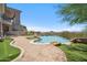 Backyard with pool, waterfall, putting green, built in seating, and desert views at 15427 E Firerock Country Club Dr, Fountain Hills, AZ 85268