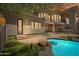 Backyard with artificial turf, pool with bar-stool seating, stone details, and a view of the main house at 15427 E Firerock Country Club Dr, Fountain Hills, AZ 85268