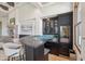 Stylish bar area features dark cabinetry, a backsplash, stone countertop, and built-in wine refrigerator at 15427 E Firerock Country Club Dr, Fountain Hills, AZ 85268