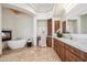 Bright bathroom featuring a soaking tub next to a fireplace, vanity and travertine floors at 15427 E Firerock Country Club Dr, Fountain Hills, AZ 85268