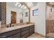 Bathroom featuring double vanity, large mirror, and decorative tile at 15427 E Firerock Country Club Dr, Fountain Hills, AZ 85268
