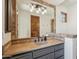 Bathroom featuring granite countertops, a stone framed mirror, vanity and overhead lighting at 15427 E Firerock Country Club Dr, Fountain Hills, AZ 85268