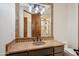 Bathroom vanity featuring beautiful countertops, a vessel sink, and stone framed mirror at 15427 E Firerock Country Club Dr, Fountain Hills, AZ 85268