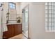 Bathroom area featuring a glass block window, towel rack, and tiled walk-in shower at 15427 E Firerock Country Club Dr, Fountain Hills, AZ 85268