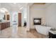 Bathroom boasting travertine floors, a soaking tub by a fireplace, and a stylish vanity at 15427 E Firerock Country Club Dr, Fountain Hills, AZ 85268