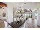 Formal dining room featuring a dark wood table, white chairs, and an elegant chandelier at 15427 E Firerock Country Club Dr, Fountain Hills, AZ 85268