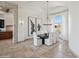 The dining area features travertine floors and large windows that provide views and natural light at 15427 E Firerock Country Club Dr, Fountain Hills, AZ 85268