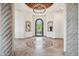 Elegant foyer with decorative tile flooring, stone columns, and an arched doorway at 15427 E Firerock Country Club Dr, Fountain Hills, AZ 85268