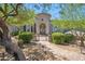 Stunning home exterior featuring a stone walkway, manicured bushes, and an arched doorway at 15427 E Firerock Country Club Dr, Fountain Hills, AZ 85268