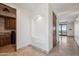 Hallway with archway and seating nook, leading to a large sliding glass door with a pool view at 15427 E Firerock Country Club Dr, Fountain Hills, AZ 85268
