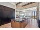 Kitchen island with bar seating, dark countertop and travertine floors overlooking the desert landscape at 15427 E Firerock Country Club Dr, Fountain Hills, AZ 85268