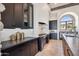 Modern kitchen featuring dark cabinetry, stainless steel appliances, and stone countertops at 15427 E Firerock Country Club Dr, Fountain Hills, AZ 85268