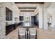 Modern kitchen featuring dark wood cabinets, a large island, and travertine flooring at 15427 E Firerock Country Club Dr, Fountain Hills, AZ 85268