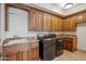Laundry room with granite countertops, a sink, and modern washer and dryer units at 15427 E Firerock Country Club Dr, Fountain Hills, AZ 85268
