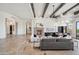 This elegant living area features beamed ceilings, stone fireplace, and easy access to bar and seating at 15427 E Firerock Country Club Dr, Fountain Hills, AZ 85268