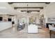 Stunning living space boasting travertine flooring, exposed wood beams, and a view into the dining room at 15427 E Firerock Country Club Dr, Fountain Hills, AZ 85268